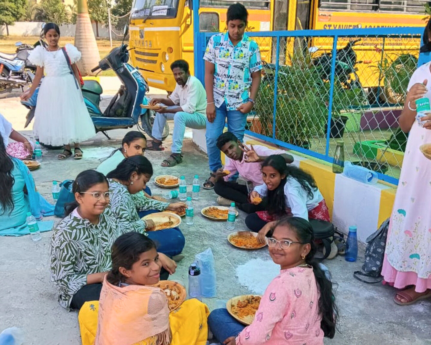 Children enjoying a meal during the Children’s Day celebration at St. Xavier’s Academy.