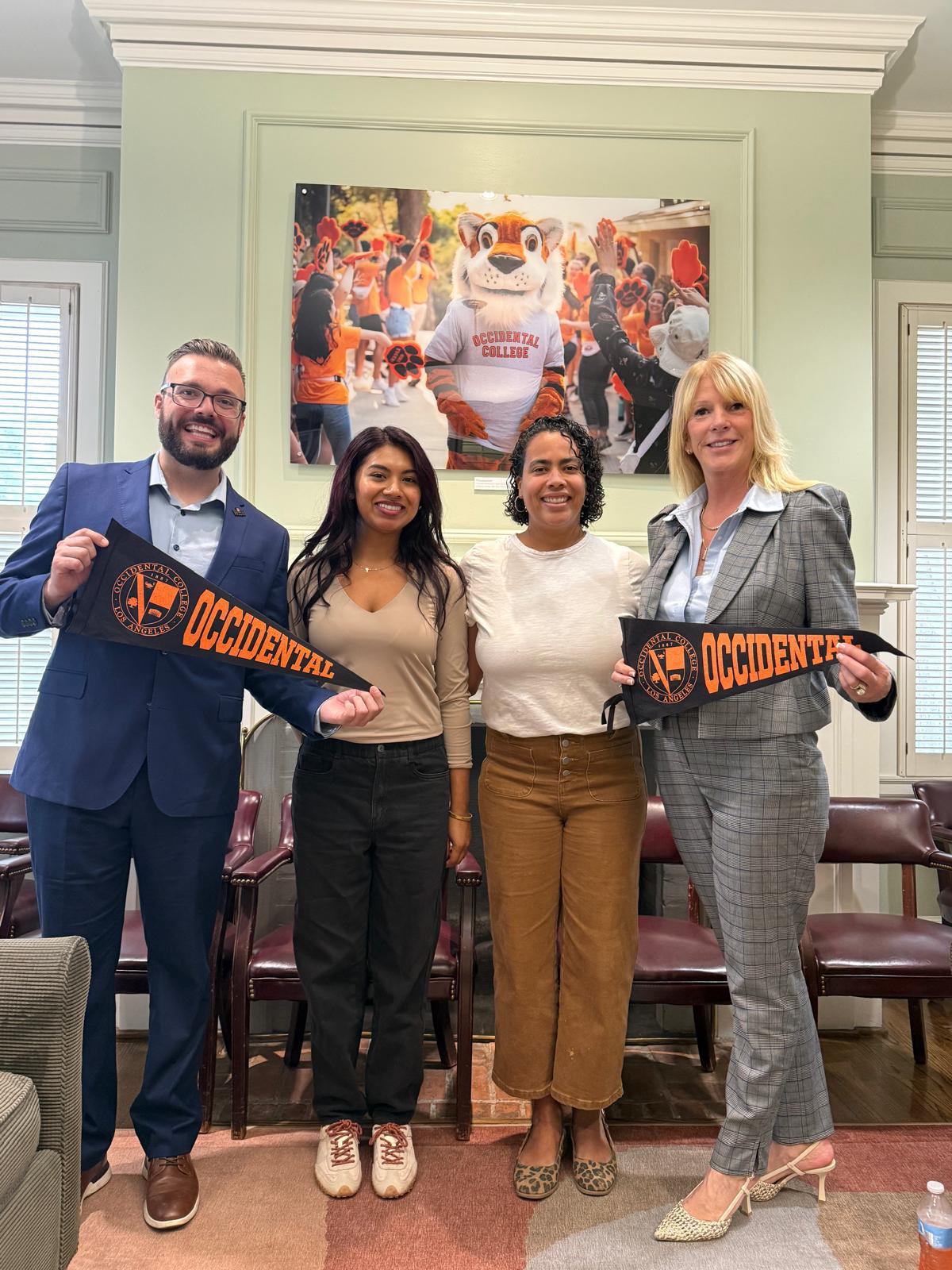 Representatives hold Occidental College pennants in the WISE partnership announcement photograph.