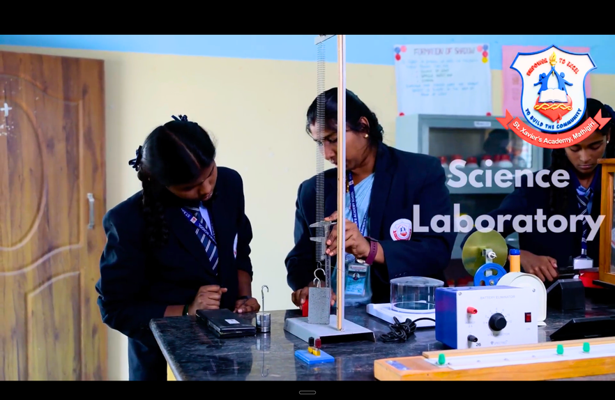 Students working with equipment in the St. Xavier’s Academy science laboratory.